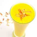 pin image of mango lassi with black text overlay on the top.