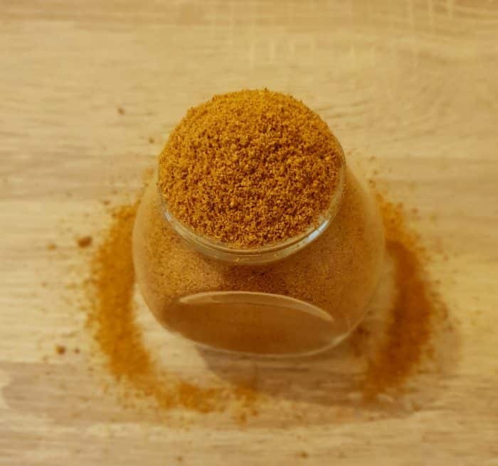 sambar masala powder in a glass jar on table