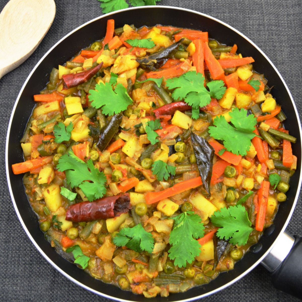 vegetable chettinad in a pan on dark grey background