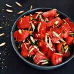 watermelon salad in black bowl.