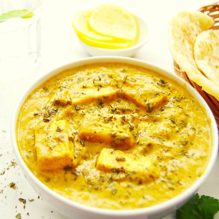 methi malai paneer curry in a white bowl.