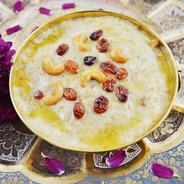 wheat payasam with dry fruits garnish in a brass bowl.