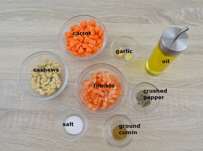 required ingredients in a bowls to make carrot sauce.