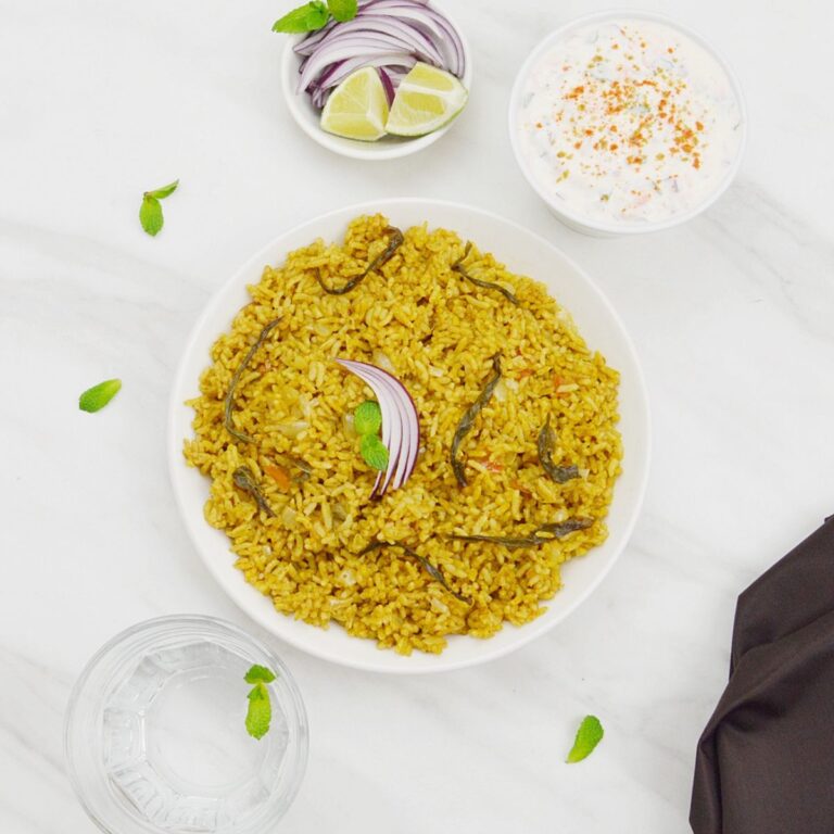 white bowl of mint rice placed on a marble.
