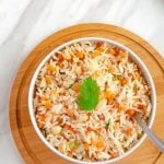 pin image of carrot rice in white bowl on wooden board with text saying carrot rice.