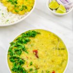 pin image of mango dal with coriander topping in a white bowl with text saying mango dal.