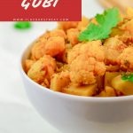 pin image of aloo gobi in white bowl with chapatis in a plate on marble background with text on red background at top.