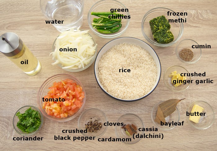 ingredients to make methi pulao placed on a table.