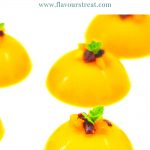 semi circle mango pudding with dry fruit and mint topping with text on top.