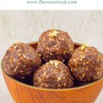 pinterest image showing brown bowl of chocolate energy balls placed on a granite with blue text overlay on top.