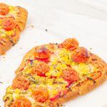 pin image showing vegetable flatbread pizzas on a marble with text overlay on top and bottom.