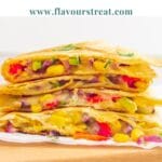 pin image of the vegetable quesadilla with blue text overlay on top.