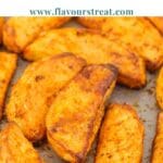 pin image of homemade baked potato wedges with blue text overlay on top.