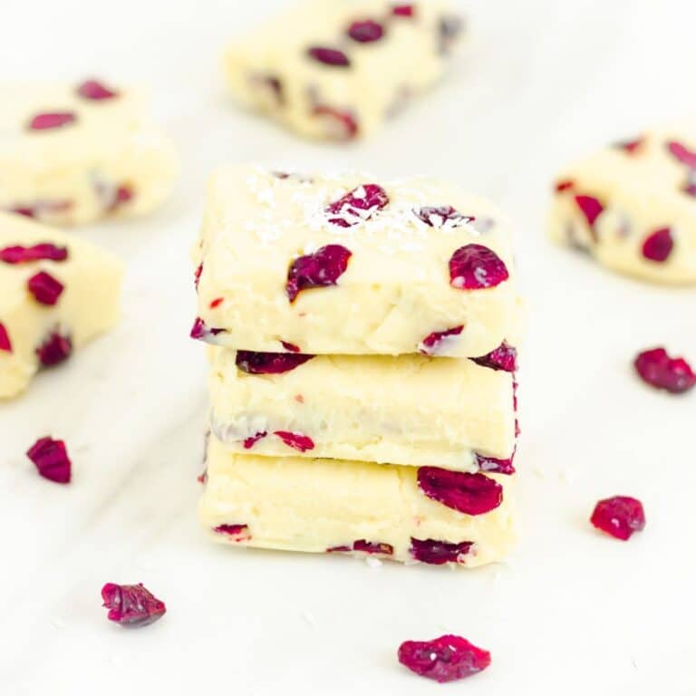 stack of 3 cranberry white chocolate fudges on a marble.