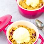 pin image of cranberry crisp in a red casserole with text overlay on top and bottom