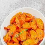 pin image of maple roasted carrots with a text overlay on the top and bottom.