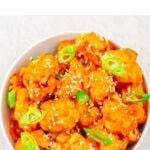 pin image of orange cauliflower with green text overlay on top.