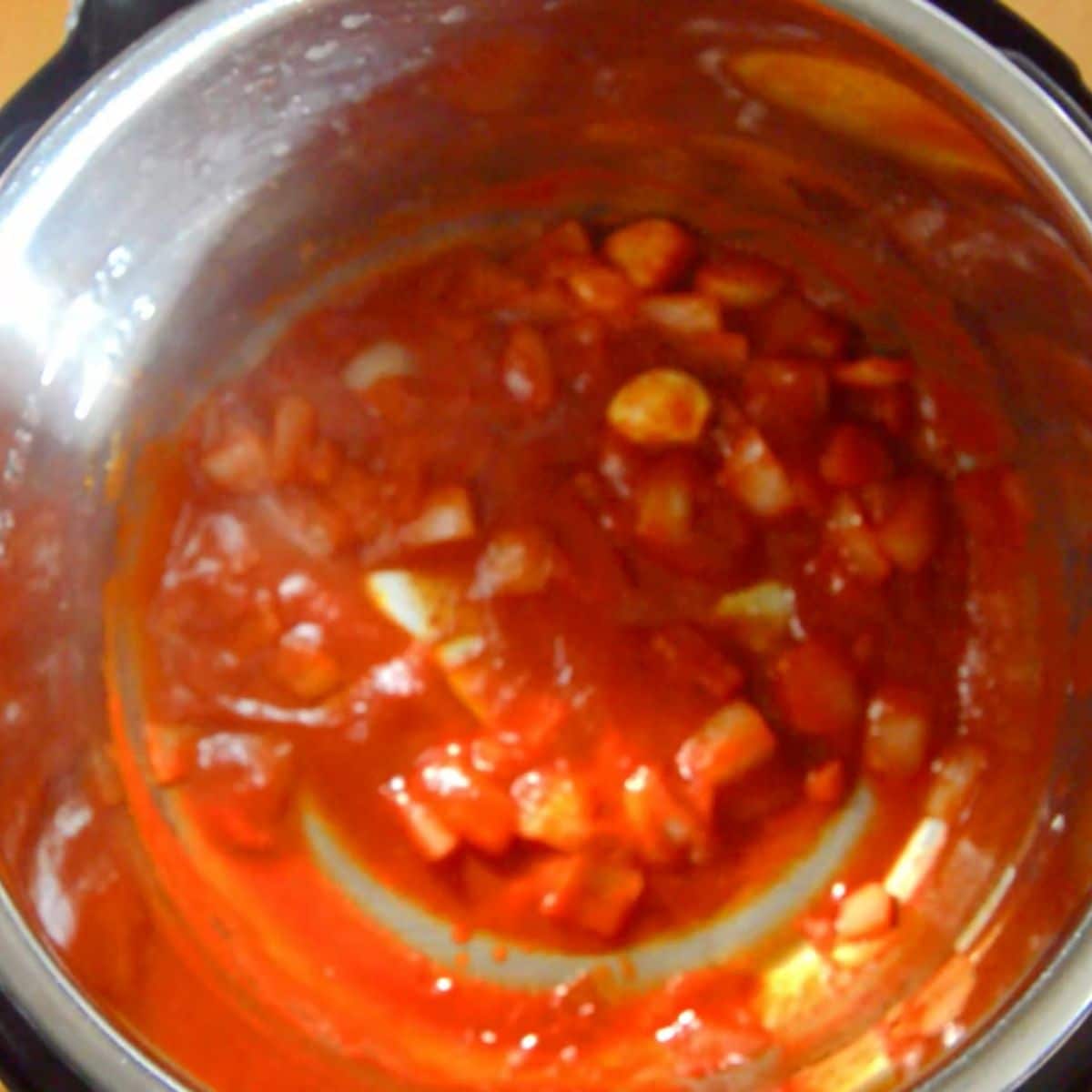onion-tomato-masala-cooking-in-steel-pot