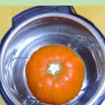 pin image of whole pumpkin inside the instant pot with pink text overlay on top.