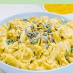 pin image of pumpkin walnut spinach pasta in a bowl with brown text overlay on top and bottom