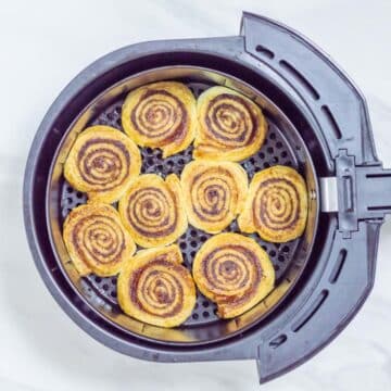 top shot of air fryer with well baked cinnamon rolls