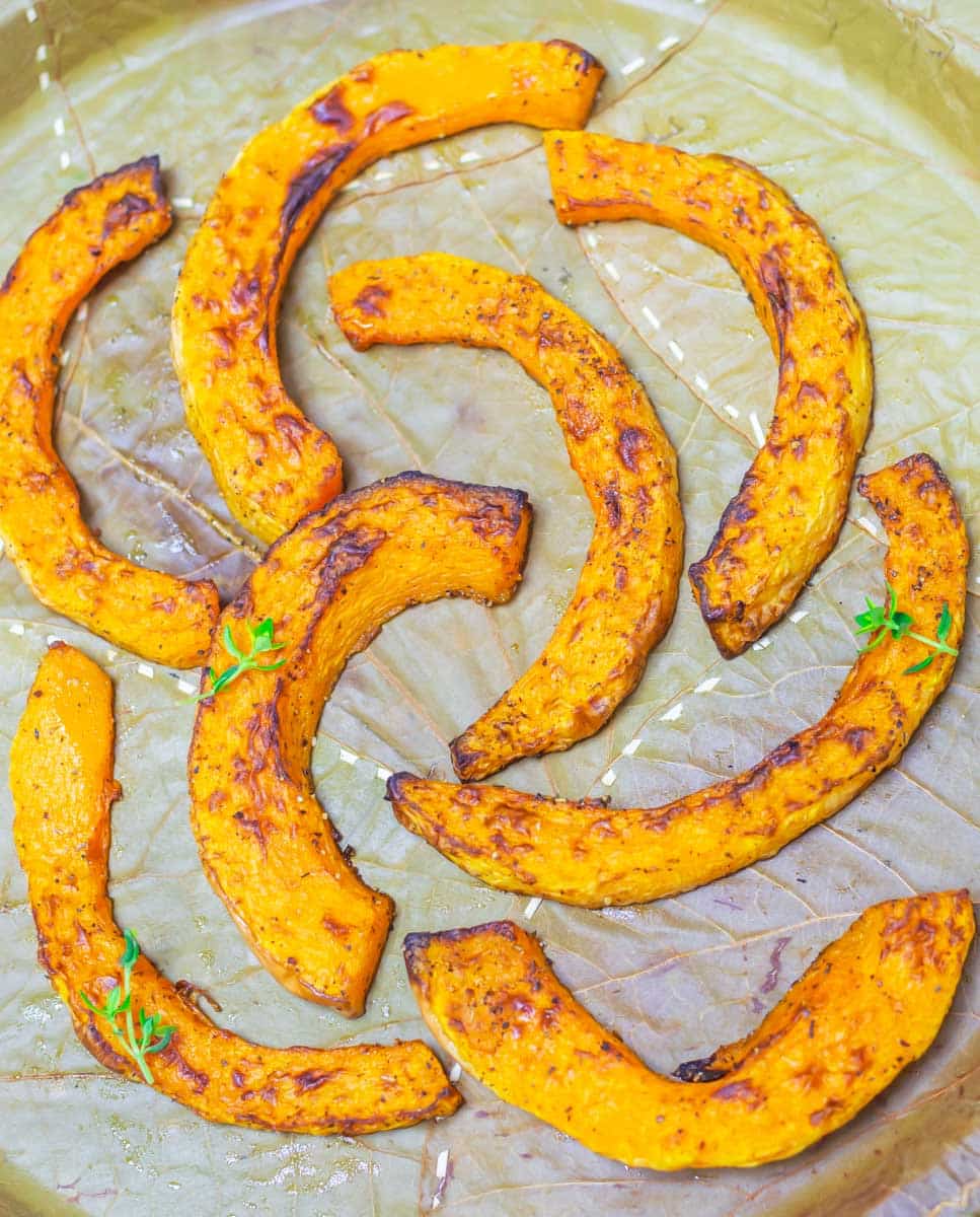 roast butternut squash rings placed on a leaf plate.
