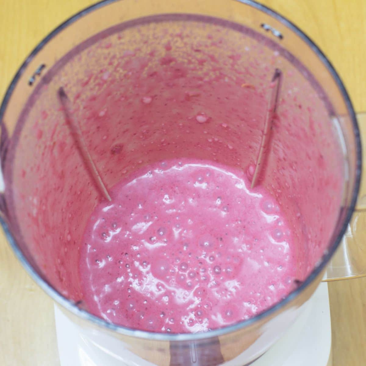 blended bright pink mixture in the blender jar.