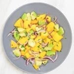 mango avocado salad in a grey bowl.