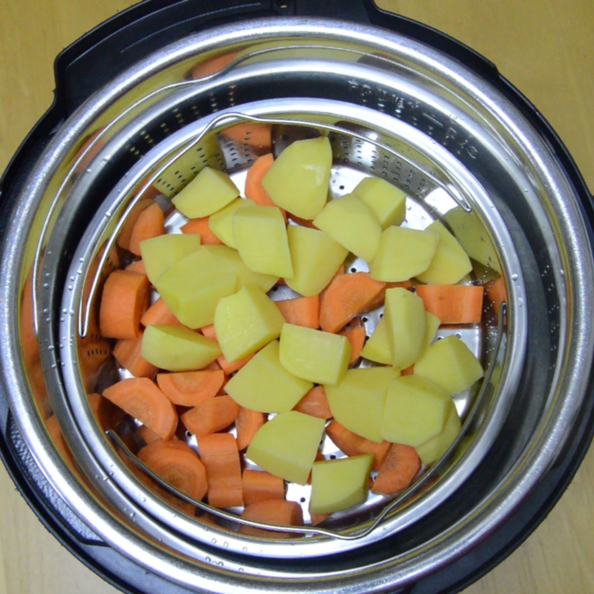carrots and potatoes in a steamer inside the instant pot.