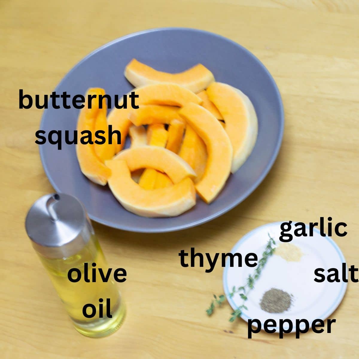butternut squash, oil and seasoning placed on a wooden table.
