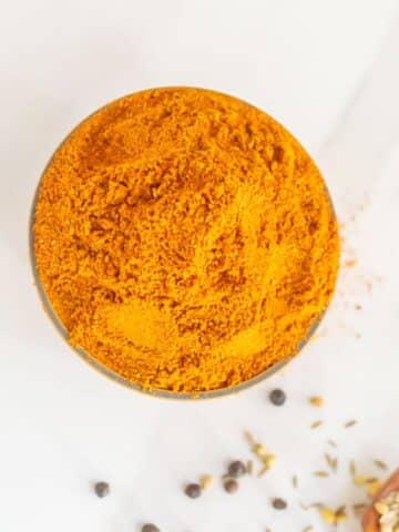 top shot of rasam powder in a bowl placed on a marble.