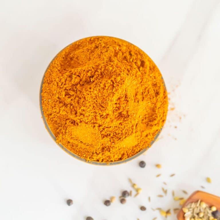 top shot of rasam powder in a bowl placed on a marble.