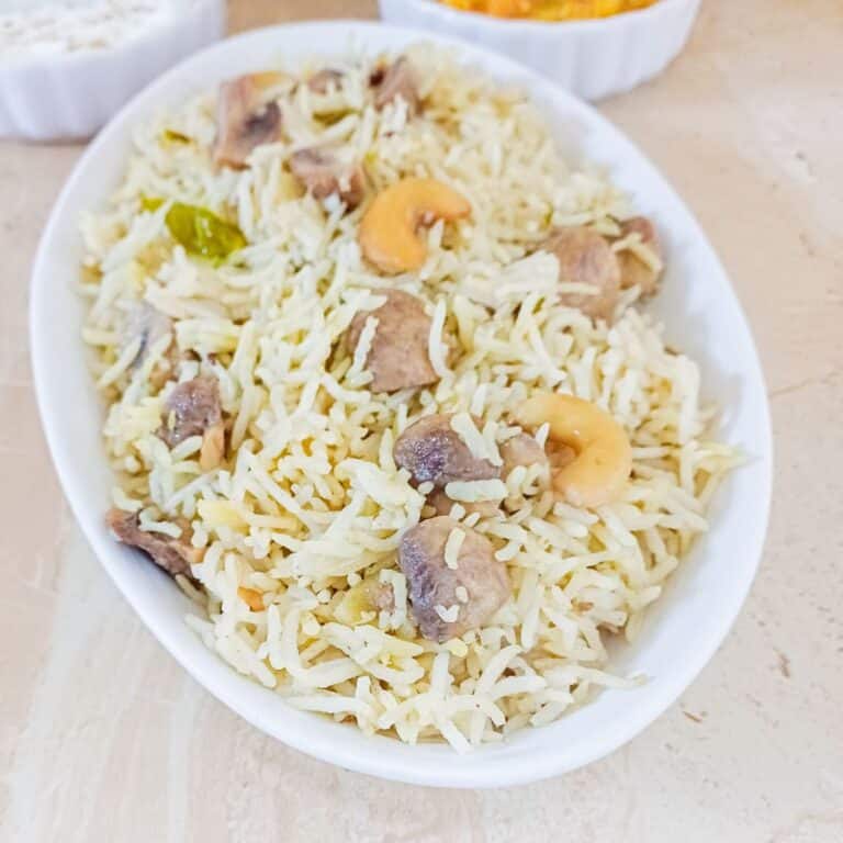 white bowl of mushroom pulao placed on a granite.