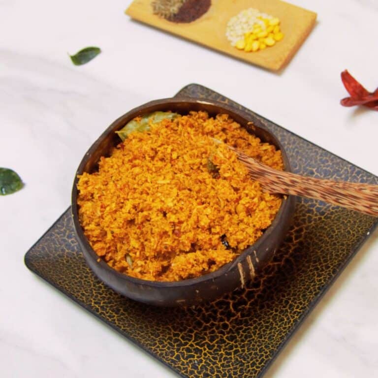 kobbari karam in a coconut shell placed on marble.