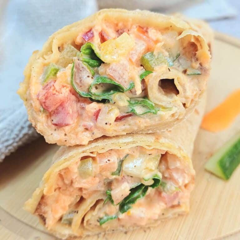 spicy yogurt vegetable wraps stacked on wooden table.