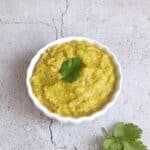 ridge gourd chutney in a white bowl placed on a tile.
