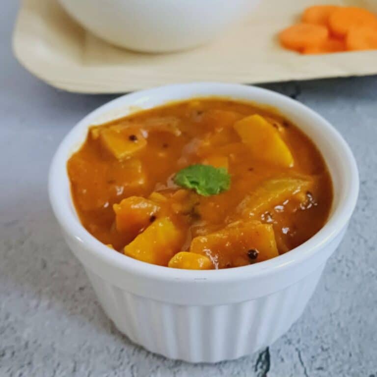 white bowl of kanda gadda pulusu placed on table .