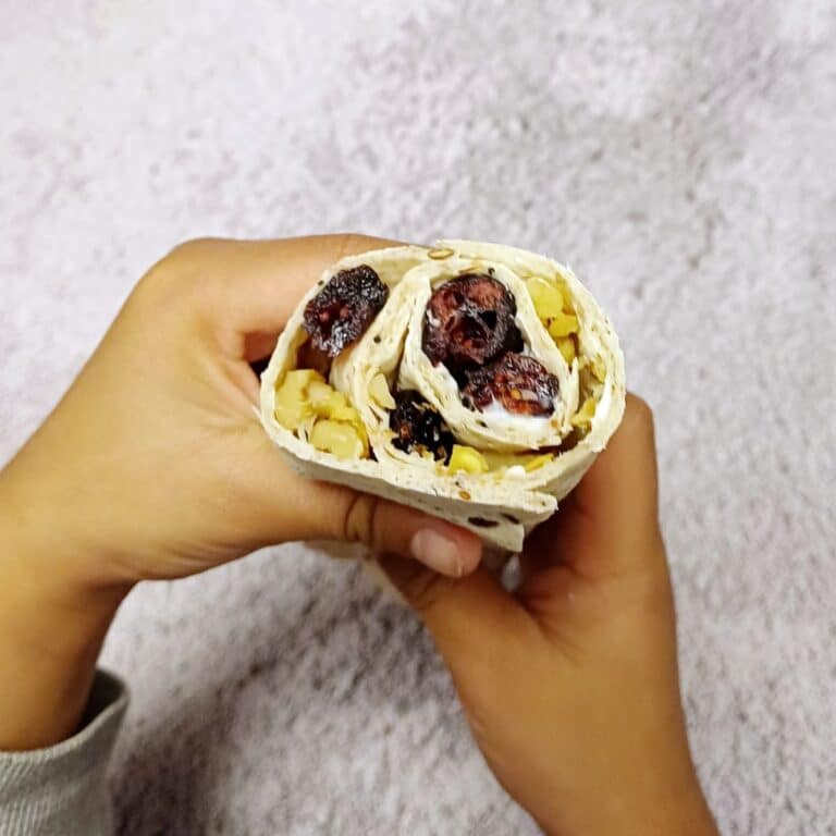 child holding cranberry walnut wrap.