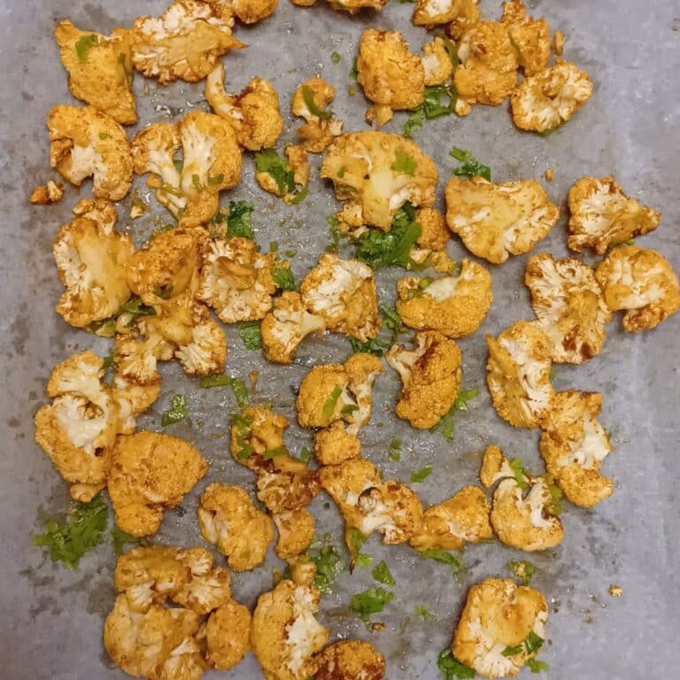 roast cauliflower on a lined baking sheet.