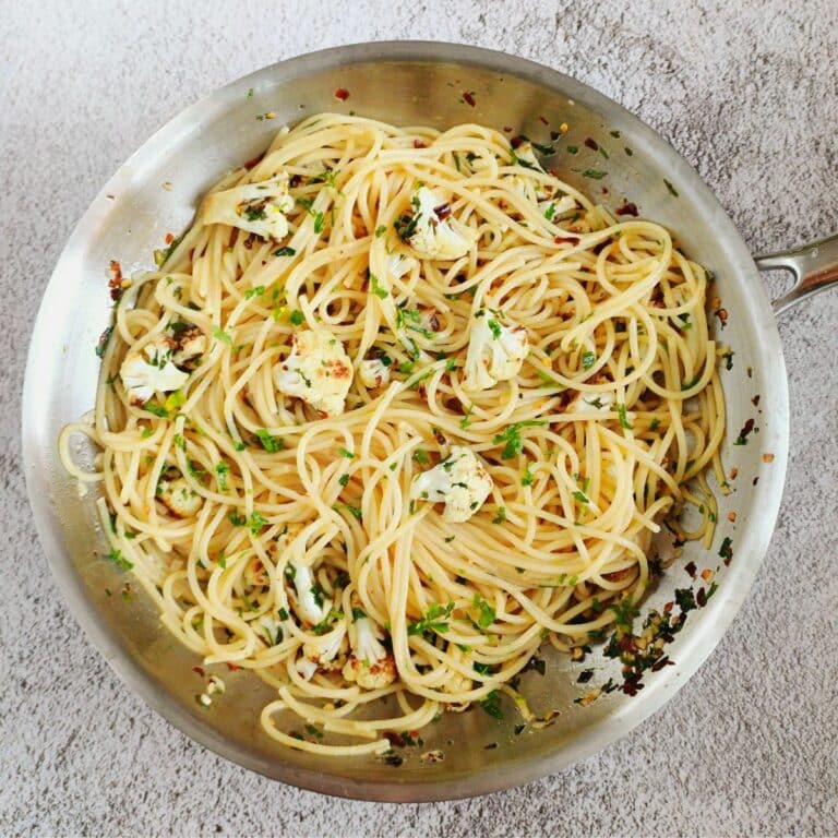 cauliflower spaghetti aglio e olio in a steel pan.