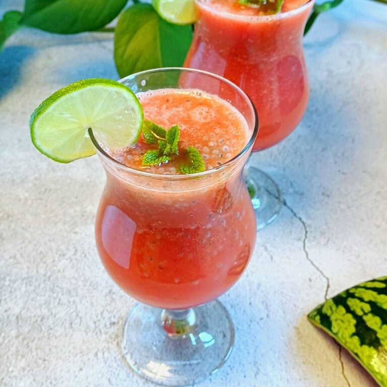 two glasses of watermelon cooler with basil seeds.