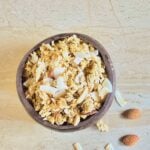 pin image of coconut granola with black text overlay on the top.
