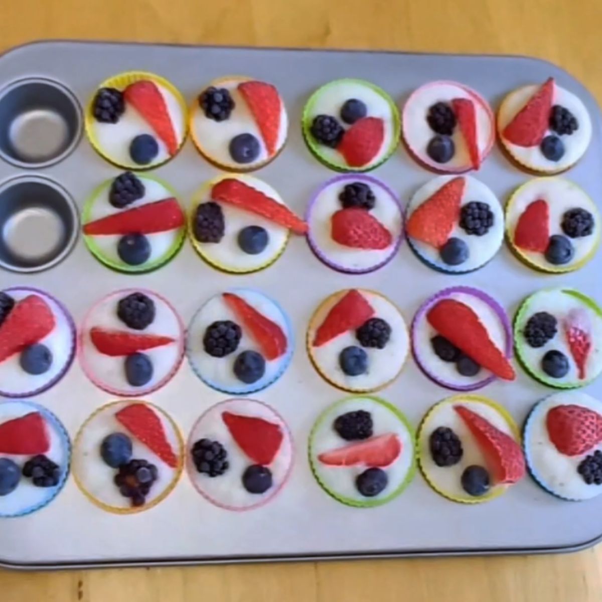 frozen mixed berry yogurt bites in a muffin tin