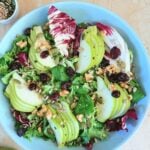 pin image of per walnut salad with maple mustard dressing with text overlay on the top.