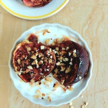 top view of white yogurt bowl topped with oven baked figs and nuts.