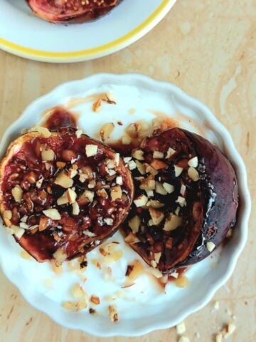 top view of white yogurt bowl topped with oven baked figs and nuts.