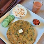 pin image of aloo palak paratha with text overlay on the top.