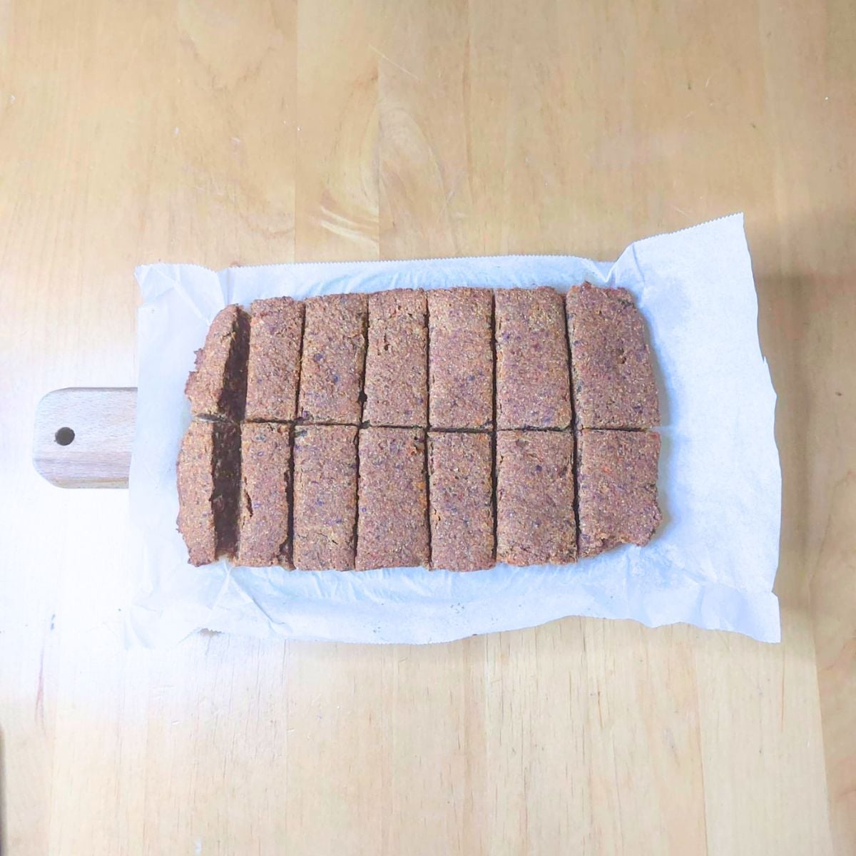 baked carrot date oat bars on parchment paper.