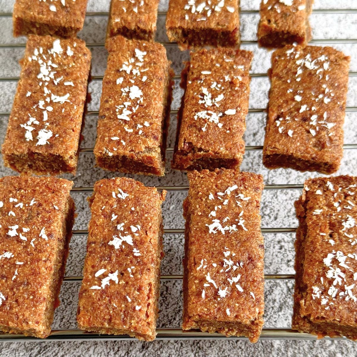 carrot oatmeal breakfast bars arranged on a wire rack. 