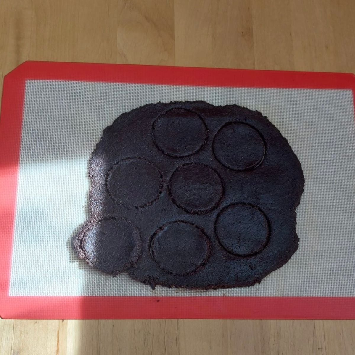 chocolate almond cookie dough spread on silicone mat 